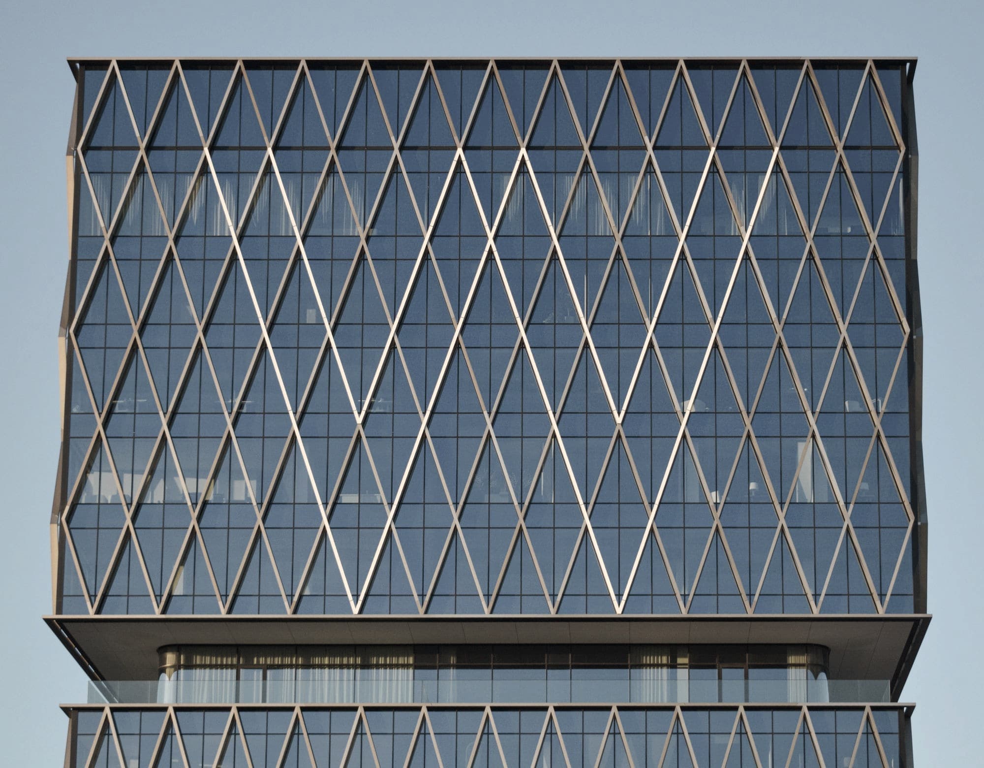 Glass building with a diamond-patterned steel facade